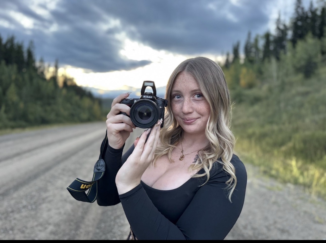 Samantha holding her camera outdoors